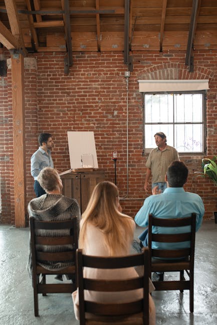 Adults attending a casual learning session in a rustic brick interior.